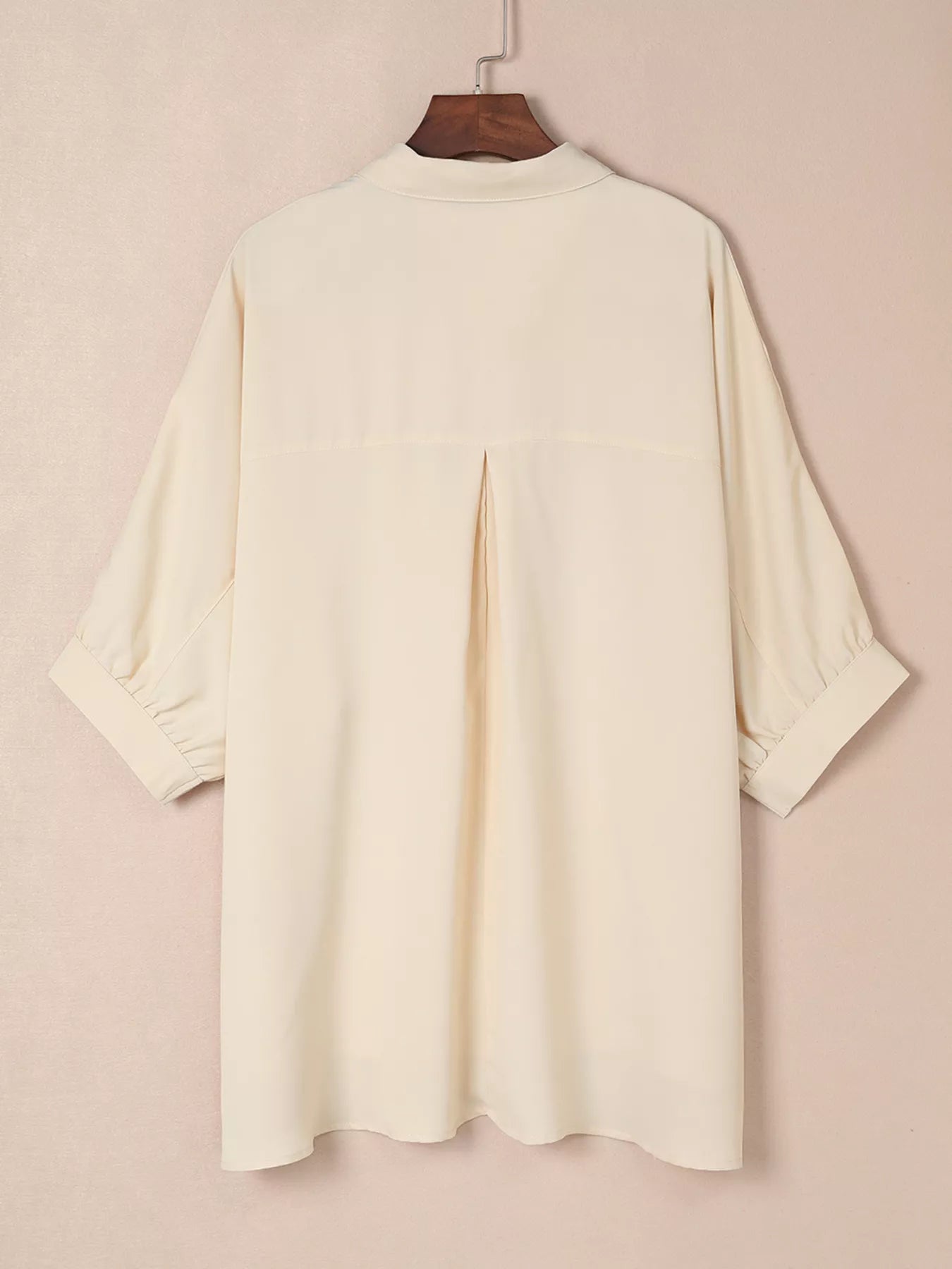 Cream-colored womens oversized 3/4 sleeve button-up blouse