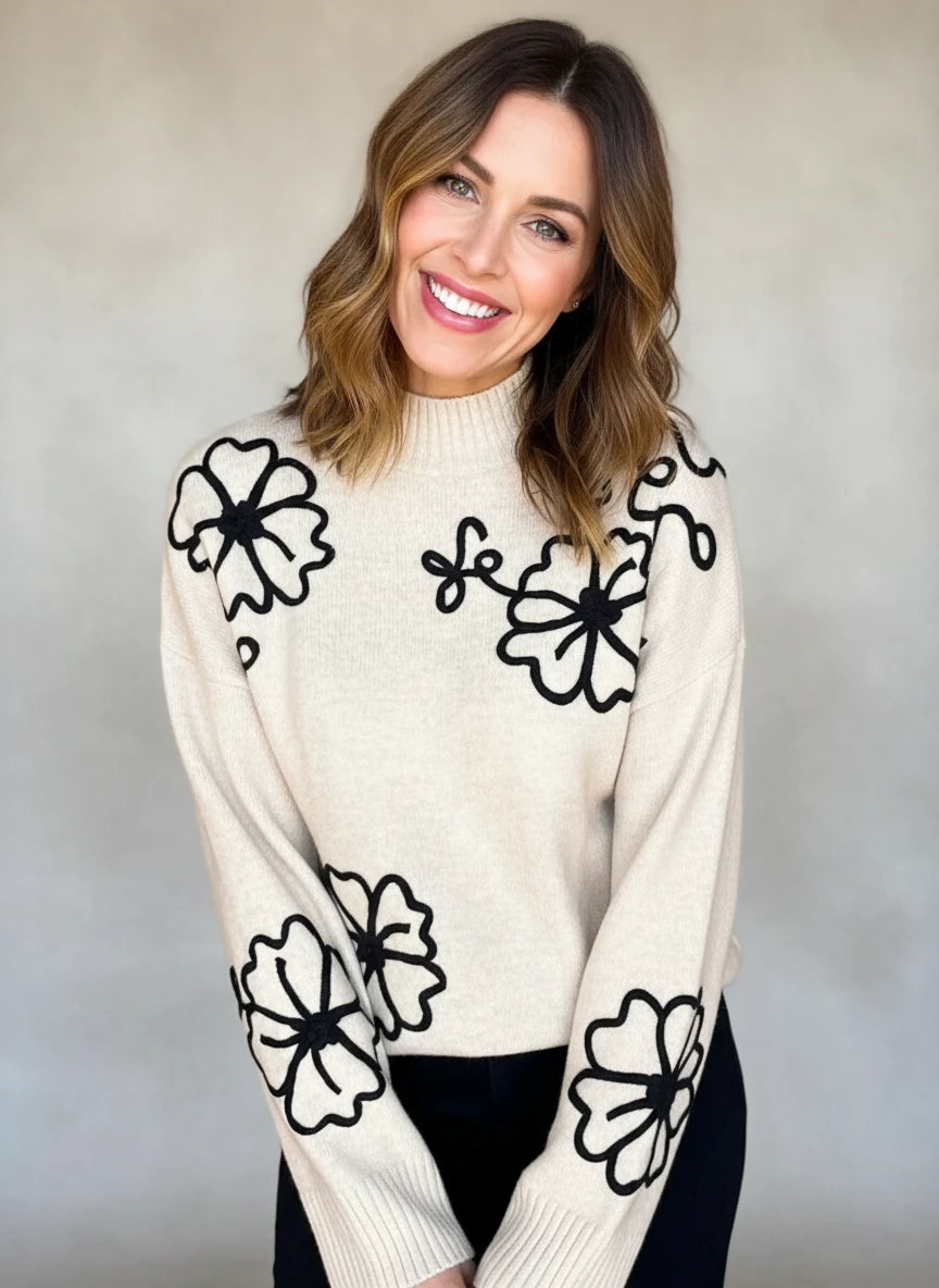 Cream floral embroidered mock neck sweater with black accents