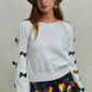 SO ME Mardi Gras white knit sweater with colorful sequined bows on sleeves