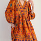 Bohemian floral print long sleeve mini dress with orange puff sleeves and v-neck