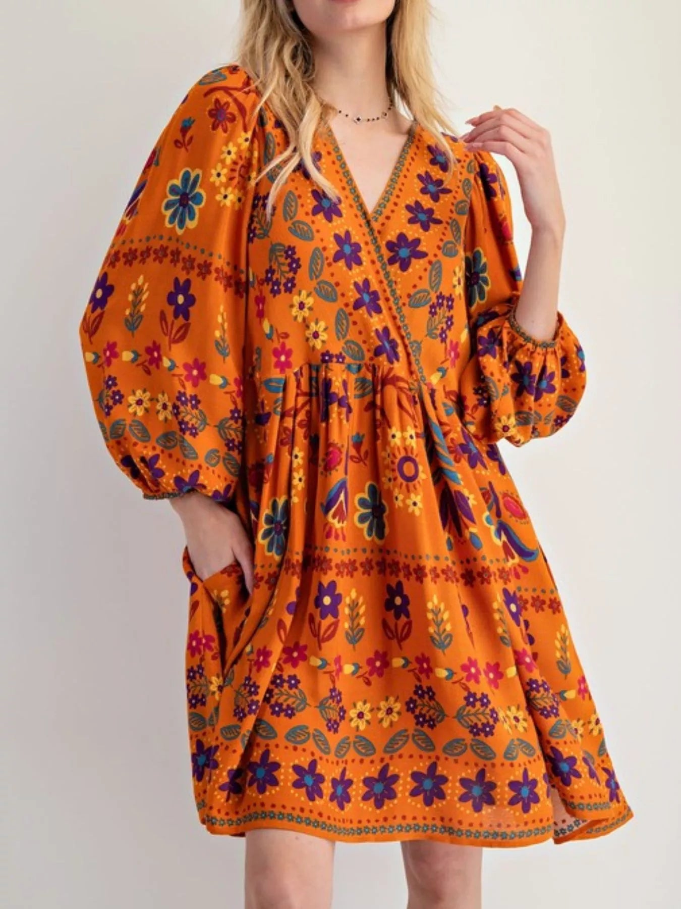 Bohemian floral print long sleeve mini dress with orange puff sleeves and v-neck