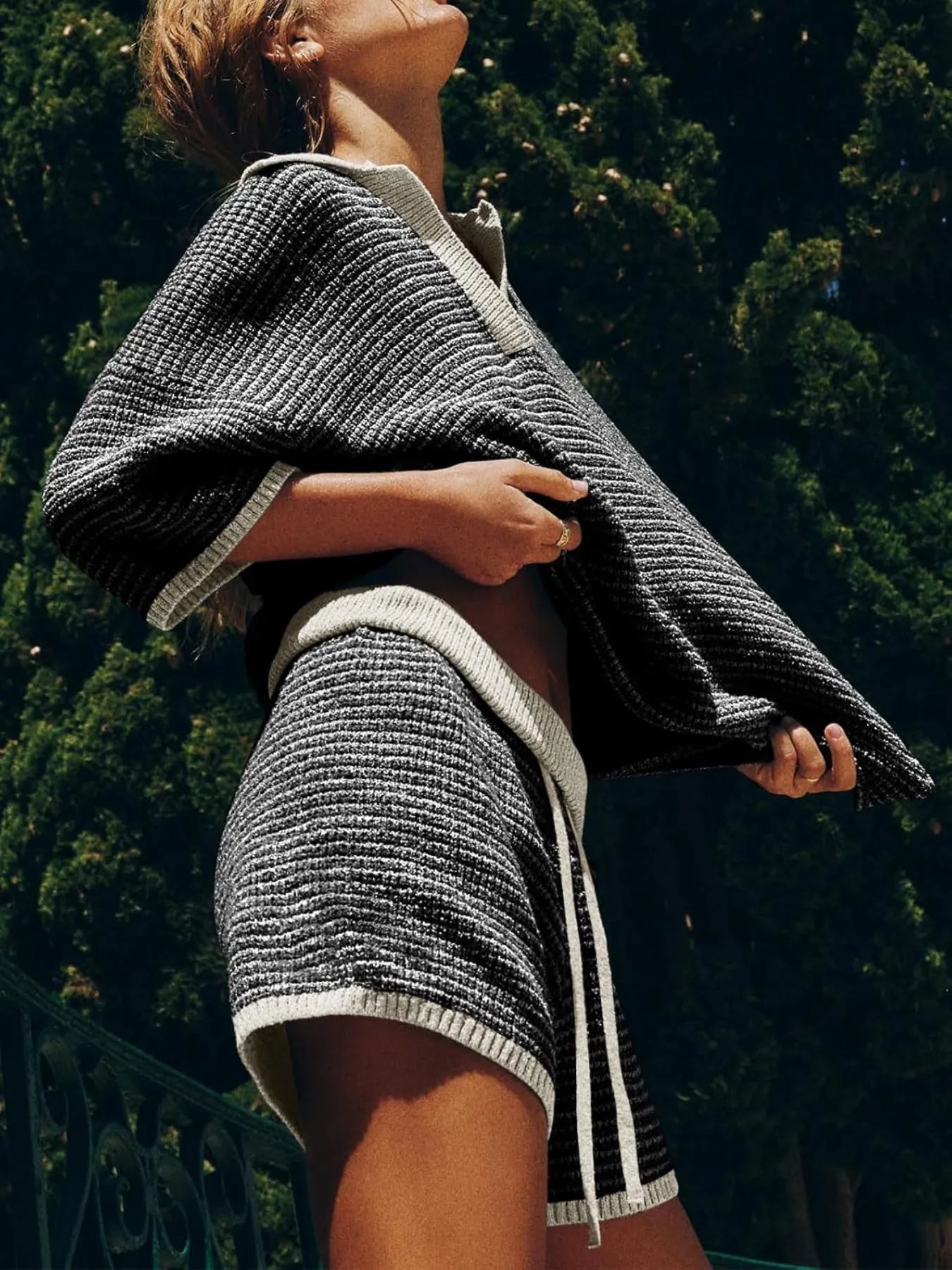 Black and white textured knit poncho with ribbed trim and stripes