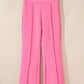 Bright pink high-waisted bootcut pants with pleats and smooth fabric