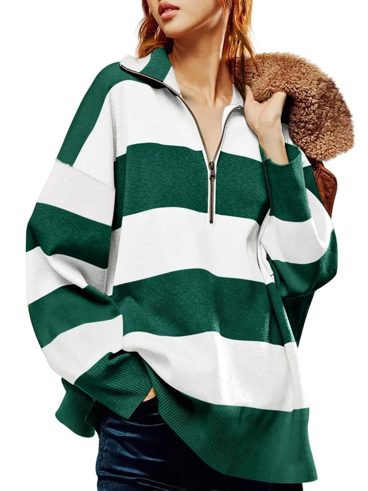 Green and white striped sweater worn by a person on a white background