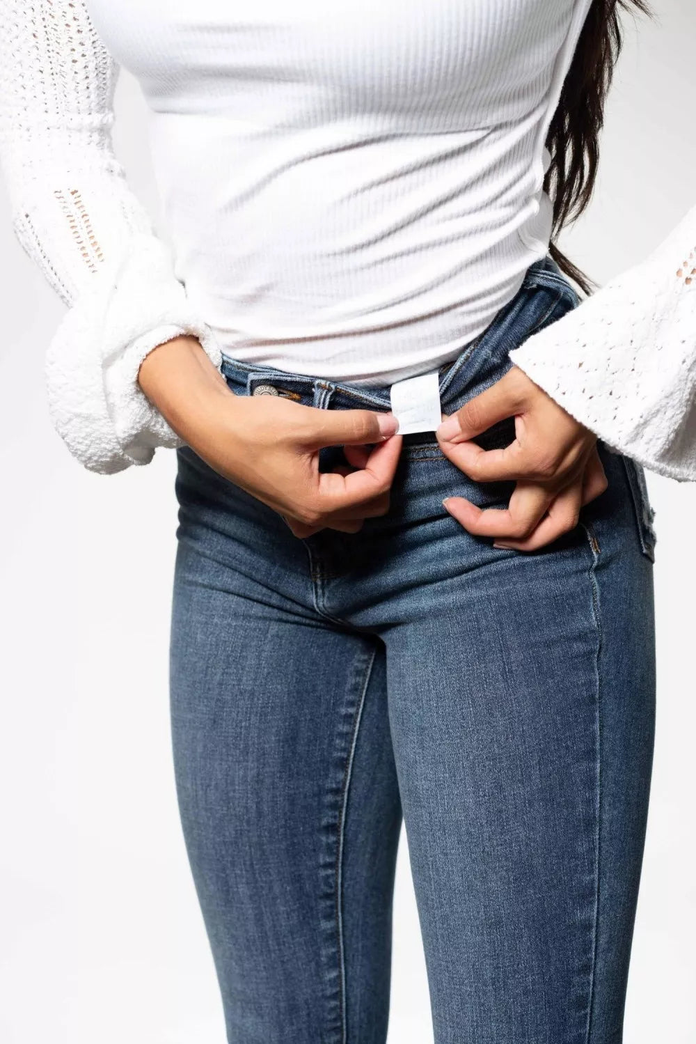 Judy Blue high waist skinny jeans in blue denim with classic fit, subtle stitching, destroy, and shark bite hem