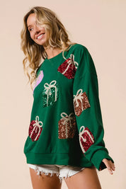 Green sequined gift box sweatshirt with white trim and long sleeves