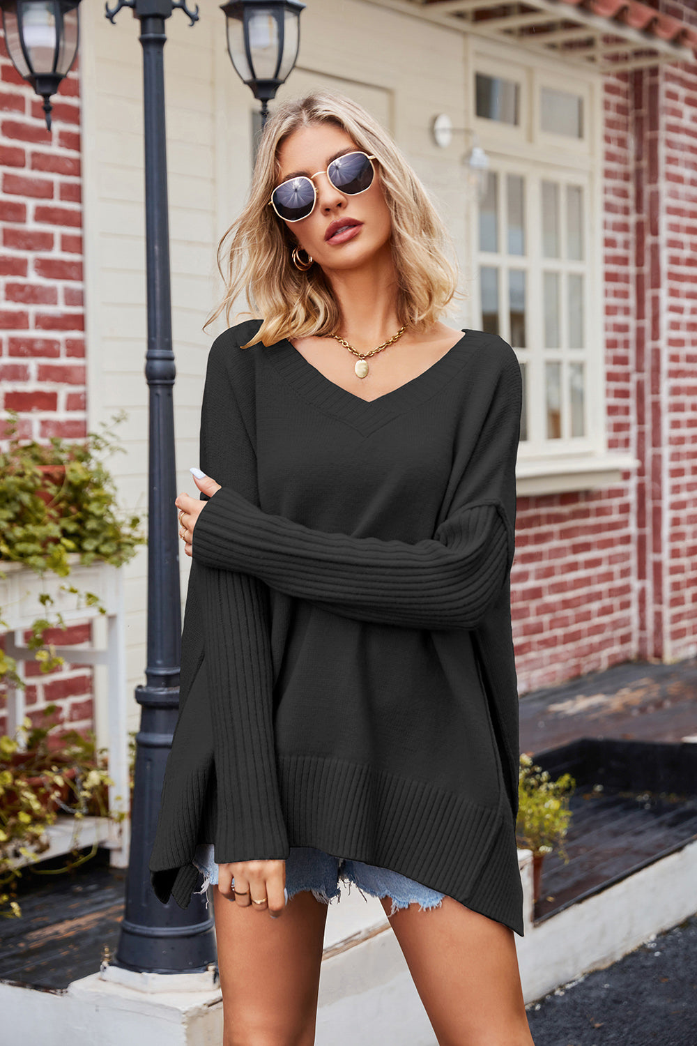 Black ribbed knit long-sleeve V-neck slit exposed seam sweater