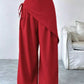 Daverri red wrap-front wide-leg pants with side tie and flowing fabric