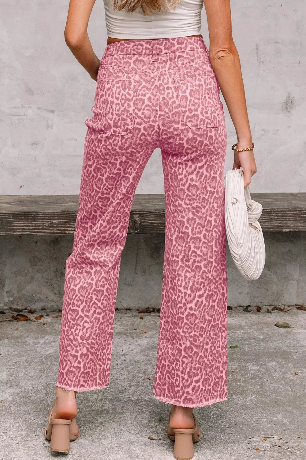 Pink leopard-print wide-leg high-waist jeans with frayed hem