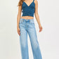 Woman in teal ribbed crop top with Risen slouchy cropped barrel jeans