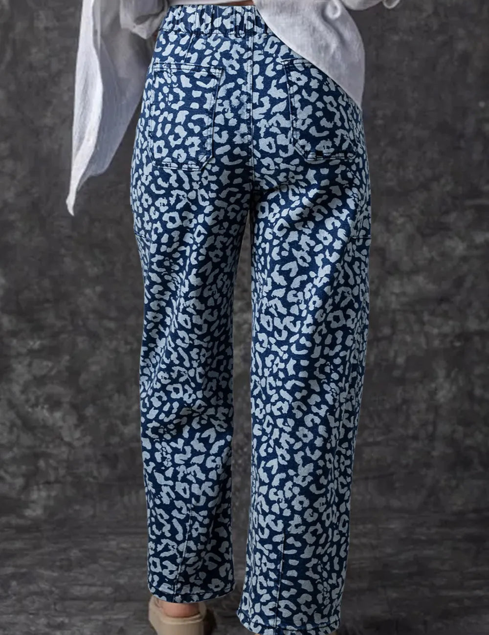 Leopard print wide leg jeans with high waist on blue background