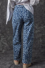 Leopard print wide leg jeans with high waist on blue background