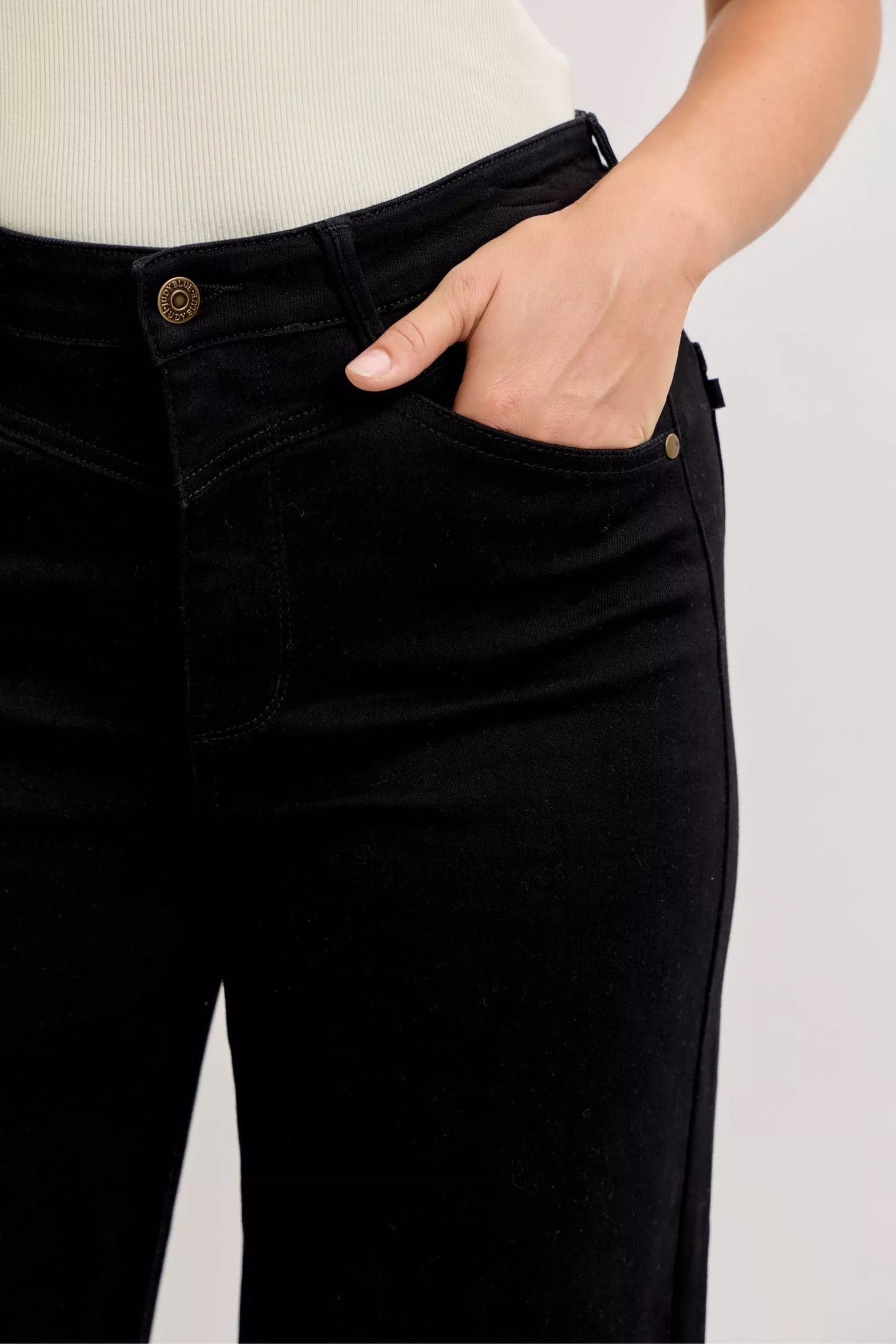 Judy Blue high-waisted wide leg jeans in black denim with fitted cut and gold button