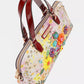 Nicole Lee Dreams Blossom dome handbag with vibrant floral pattern, red handles, gold hardware