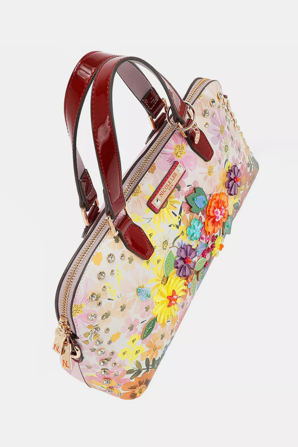 Nicole Lee Dreams Blossom dome handbag with vibrant floral pattern, red handles, gold hardware