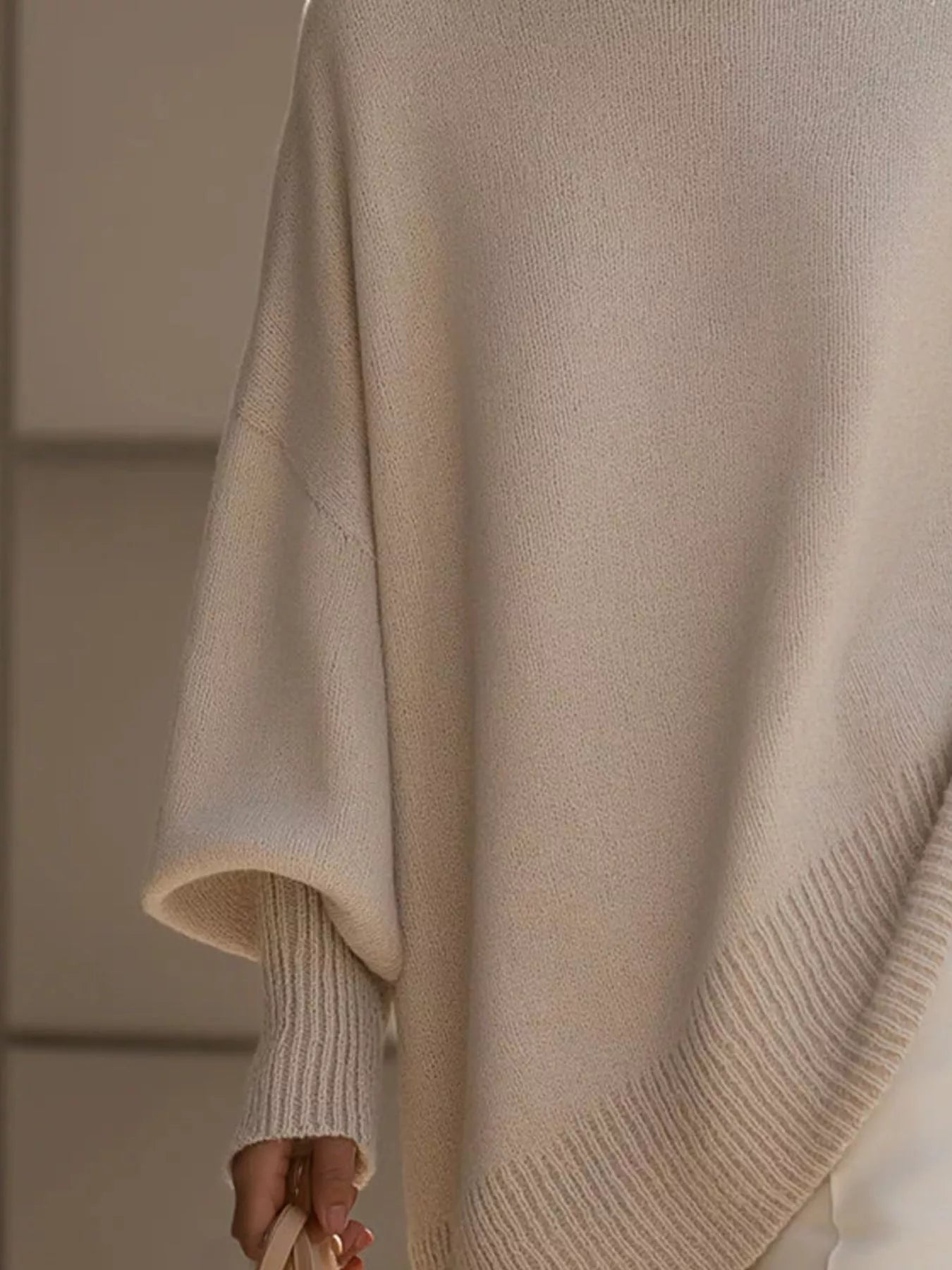 Cream-colored soft-knit oversized batwing sleeve poncho sweater