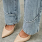 Beige pointed-toe flats with sleek finish and Saige Denim jeans