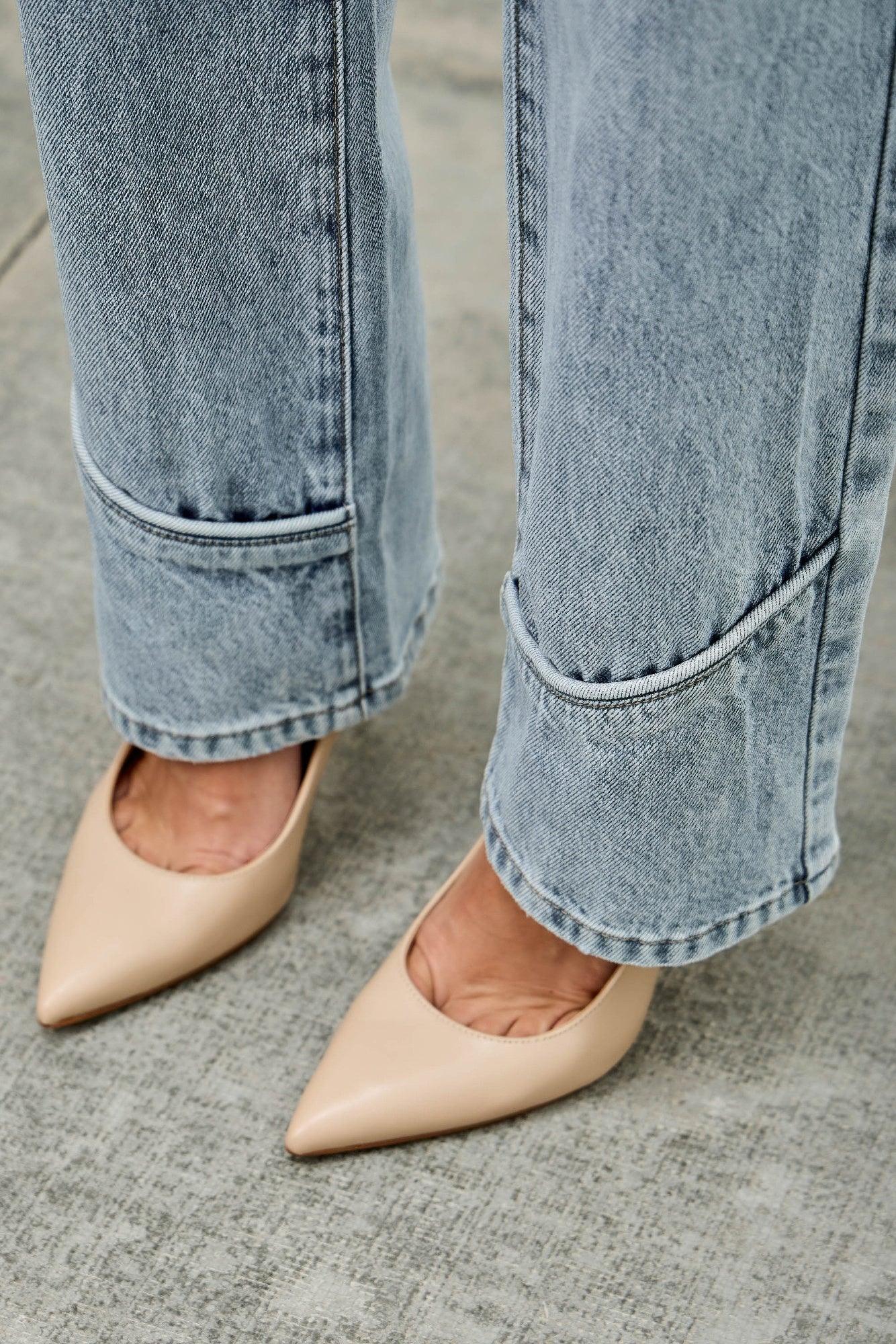 Beige pointed-toe flats with sleek finish and Saige Denim jeans