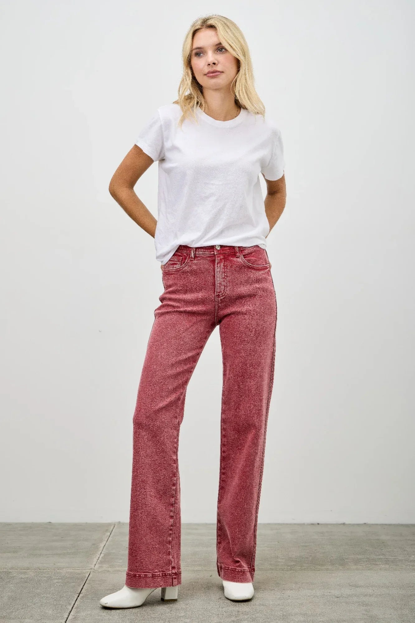 High-waisted red Saige denim jeans with straight-leg cut and subtle fading