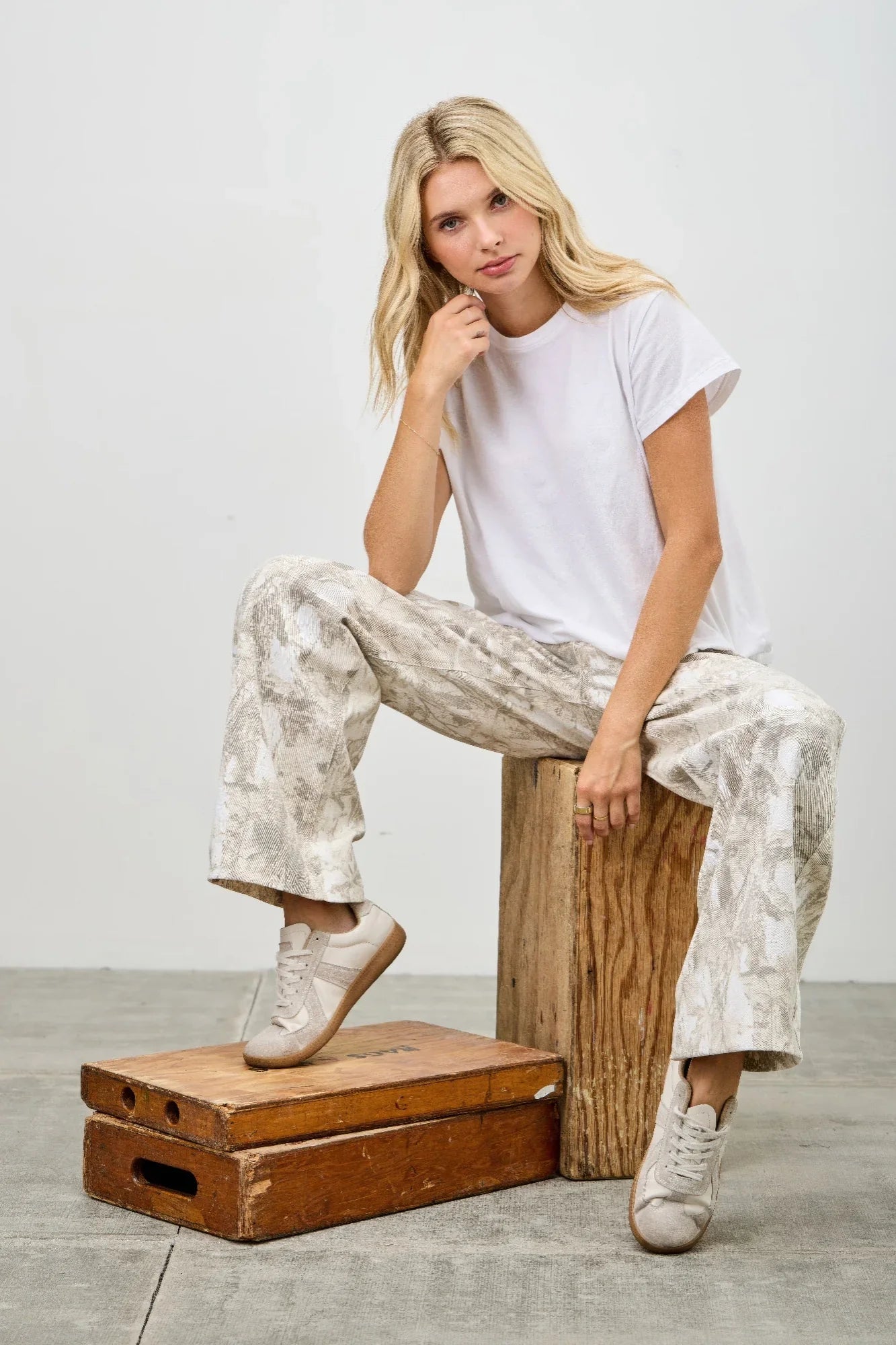 Plus size woman in white t-shirt and patterned wide-leg pants