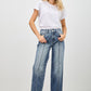 High-waisted wide-leg denim jeans in medium blue wash with fading and stitching
