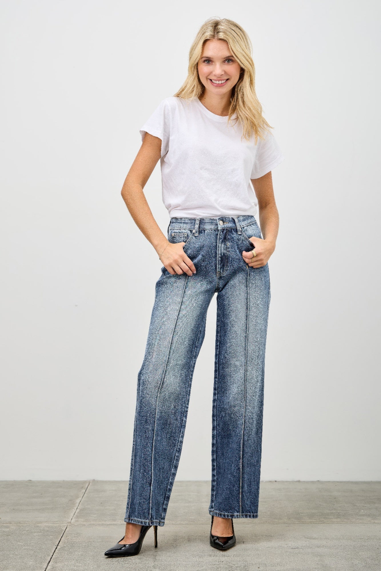 High-waisted wide-leg denim jeans in medium blue wash with fading and stitching