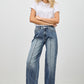 High-waisted wide-leg denim jeans in medium blue wash with fading and stitching