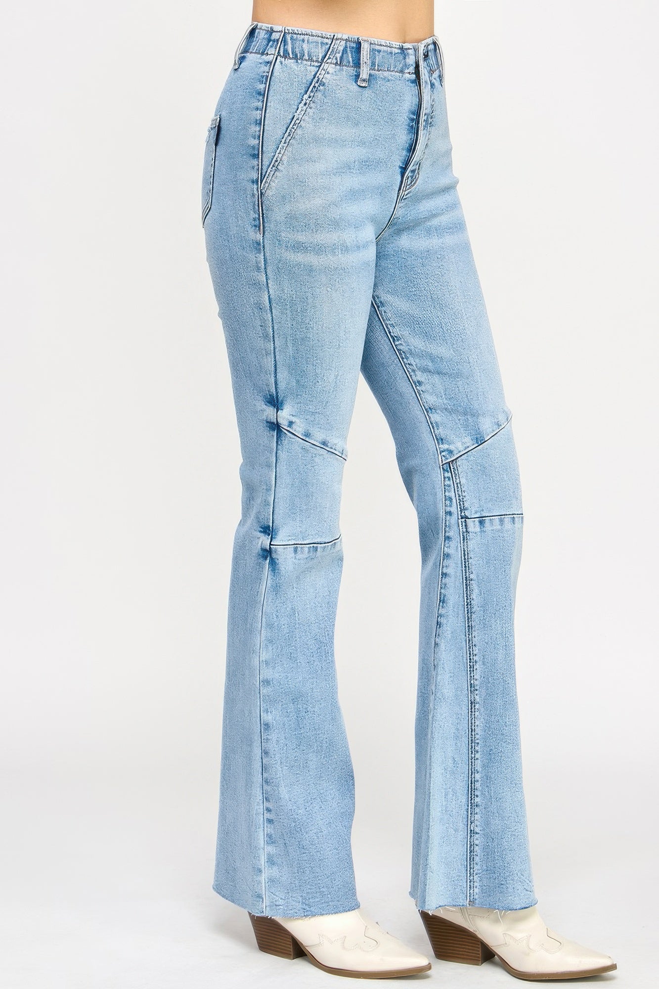 High-rise light-wash denim flare jeans with thigh and knee seam detailing
