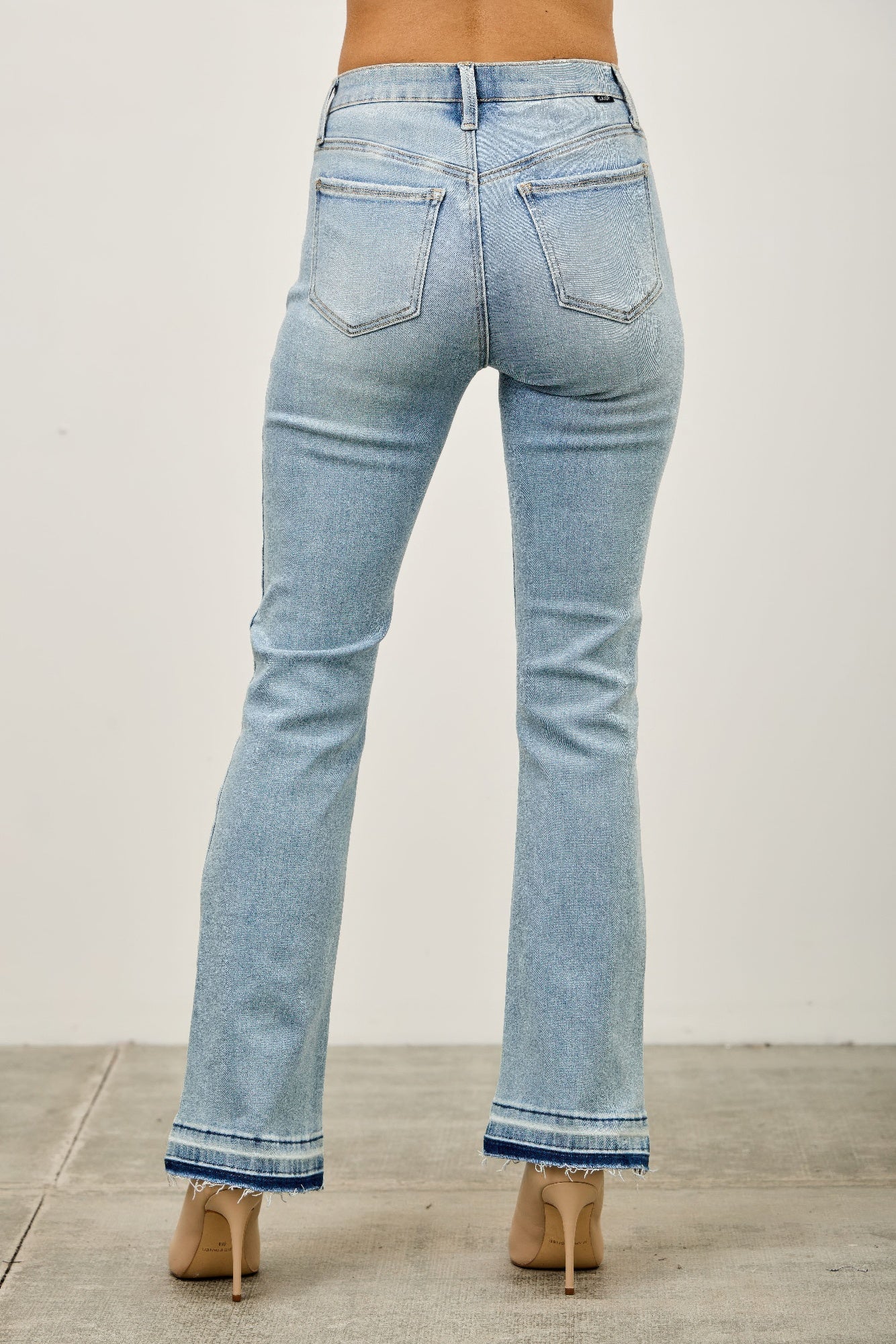 Mid-rise light-wash denim flare jeans with frayed hems