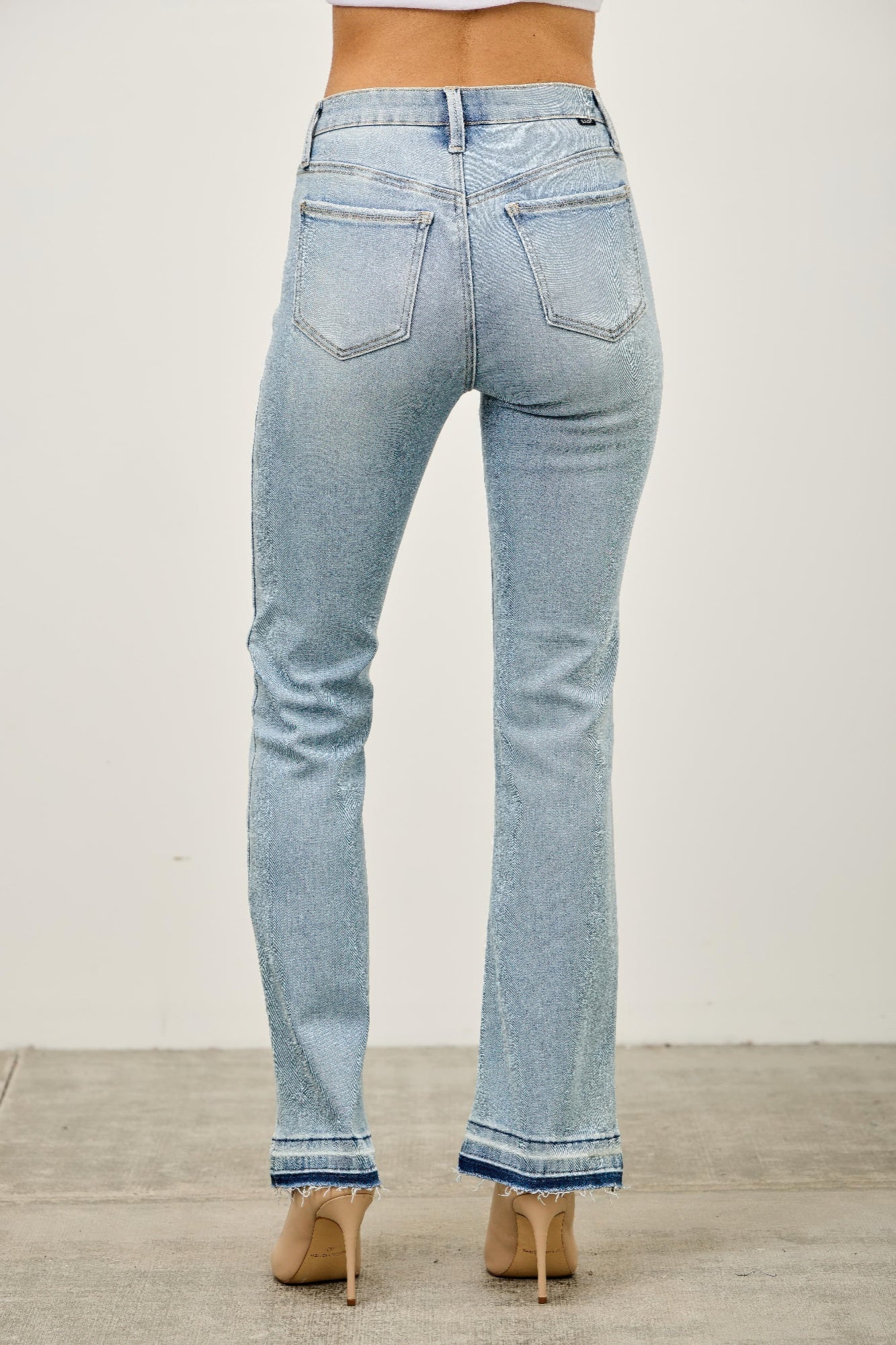 Mid rise light-wash denim flare jeans with distressed texture and frayed hems