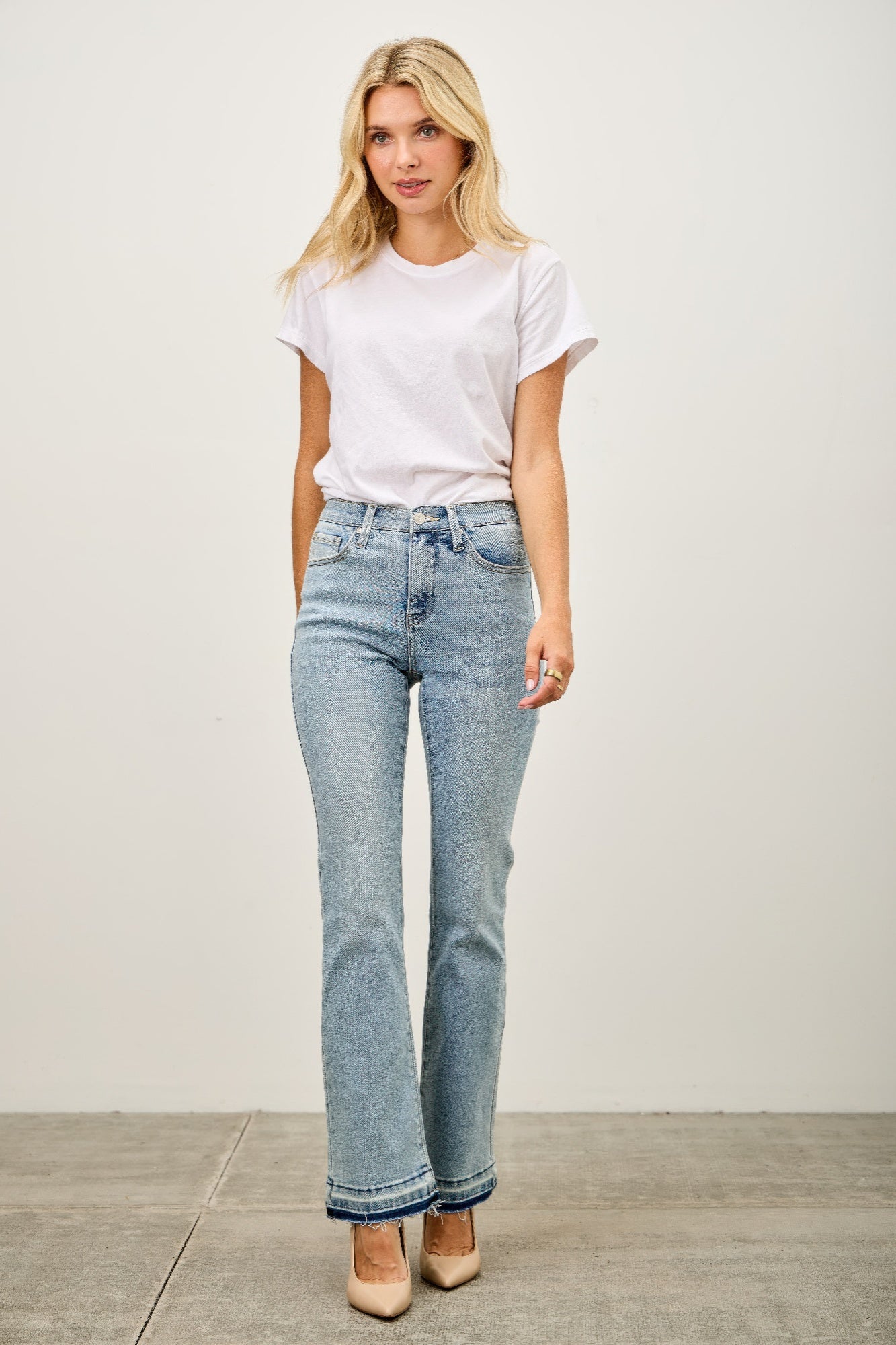 High-waisted light blue faded flare jeans with rolled cuffs