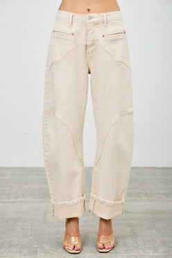 High-rise beige wide-leg denim pants with rolled cuffs and stitched paneling