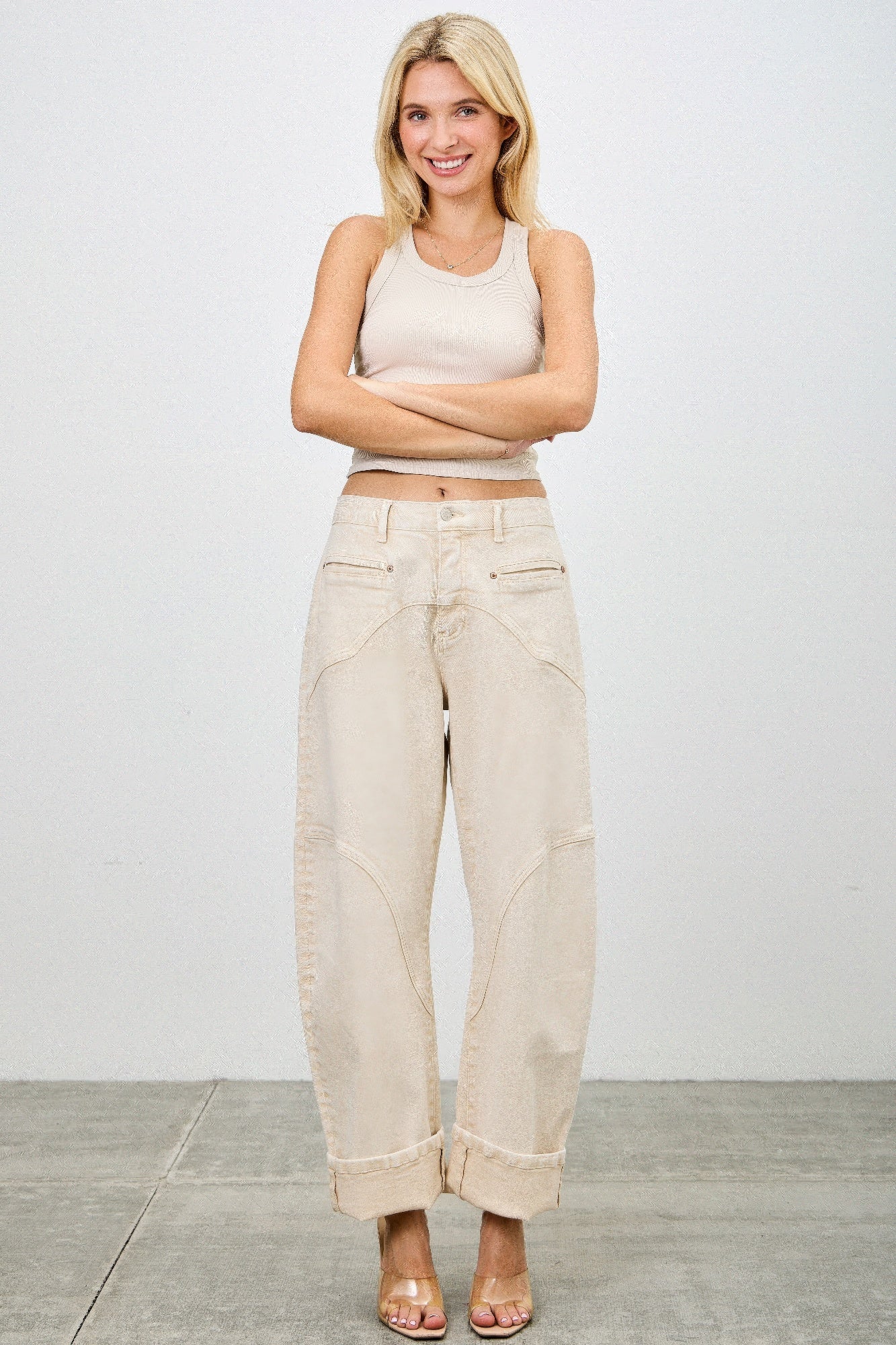 Beige high-rise wide-leg jeans with rolled cuffs and subtle stitching