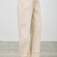 High-rise beige wide-leg denim pants with rolled cuffs and patchwork