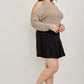 Plus size cold-shoulder knit sweater with black shorts and loafers
