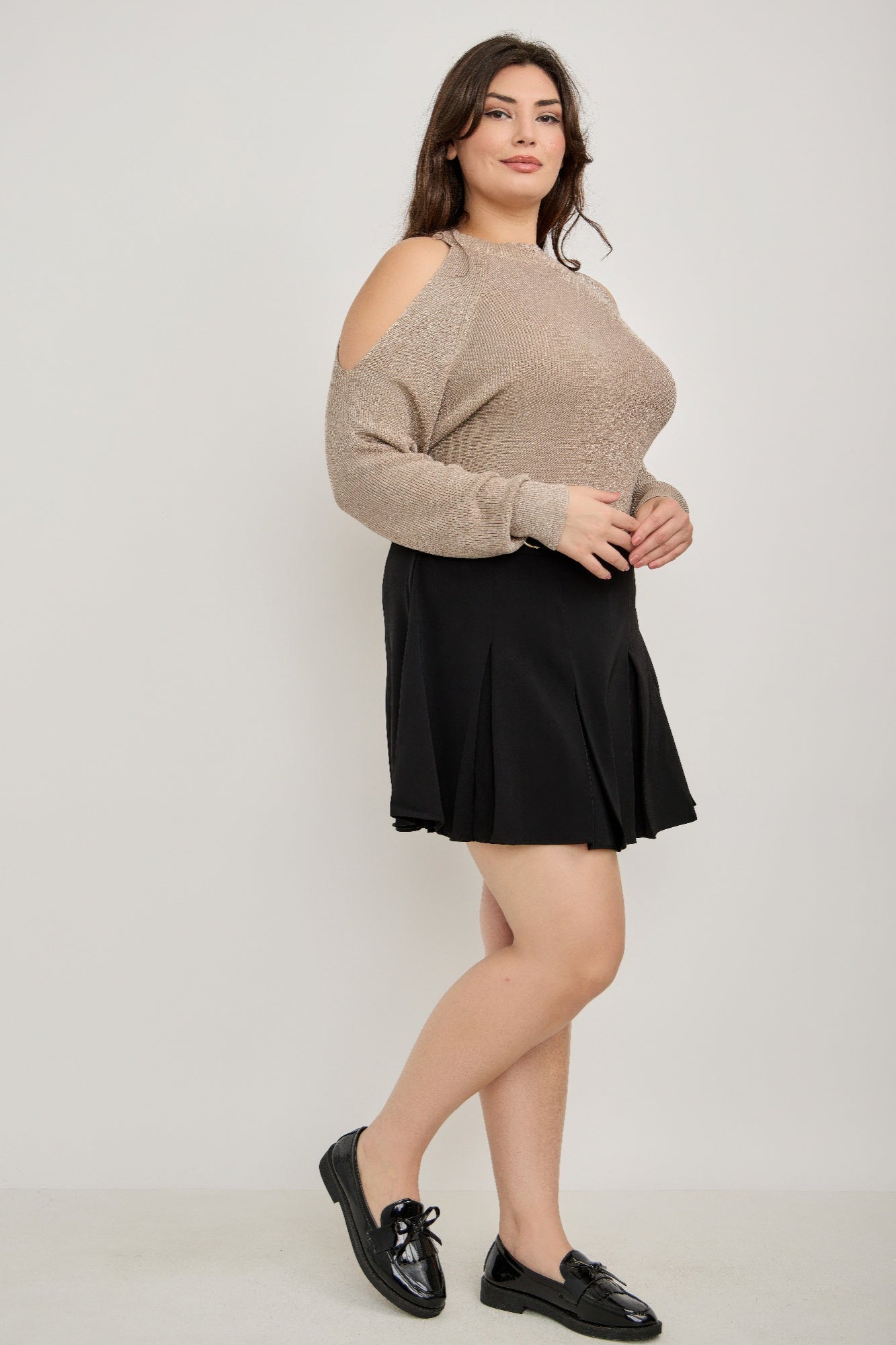 Plus size cold-shoulder knit sweater with black shorts and loafers