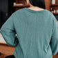 Teal ribbed knit relaxed-fit V-neck sweater with long sleeves