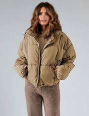 Beige oversized puffer jacket with fur-lined hood and zip-up collar