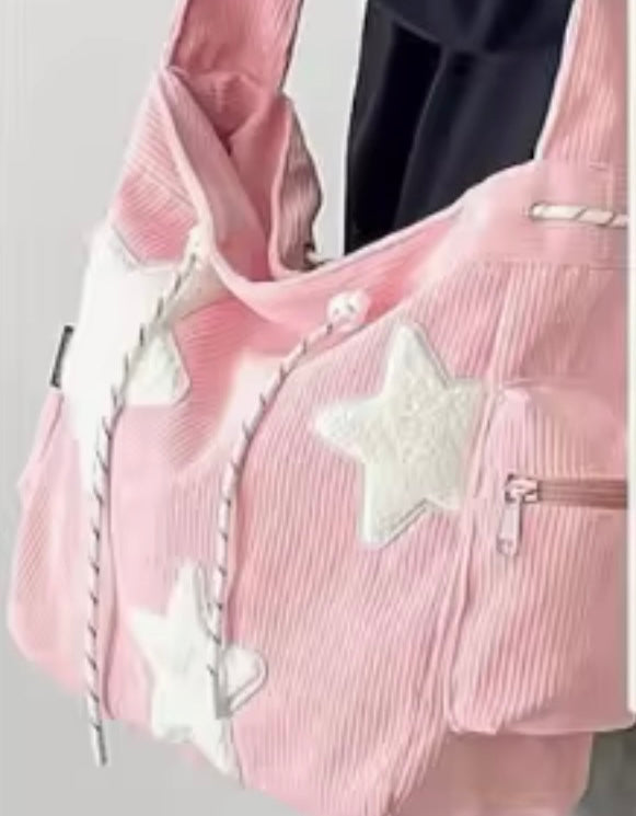 Pink corduroy star applique crossbody bag with drawstring closure
