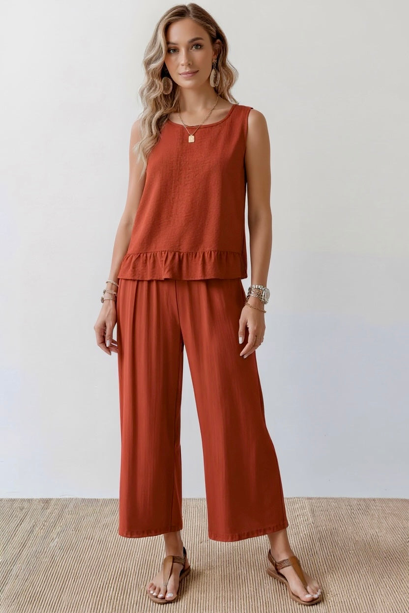 Daverri rust sleeveless ruffle hem tank with pleats front view