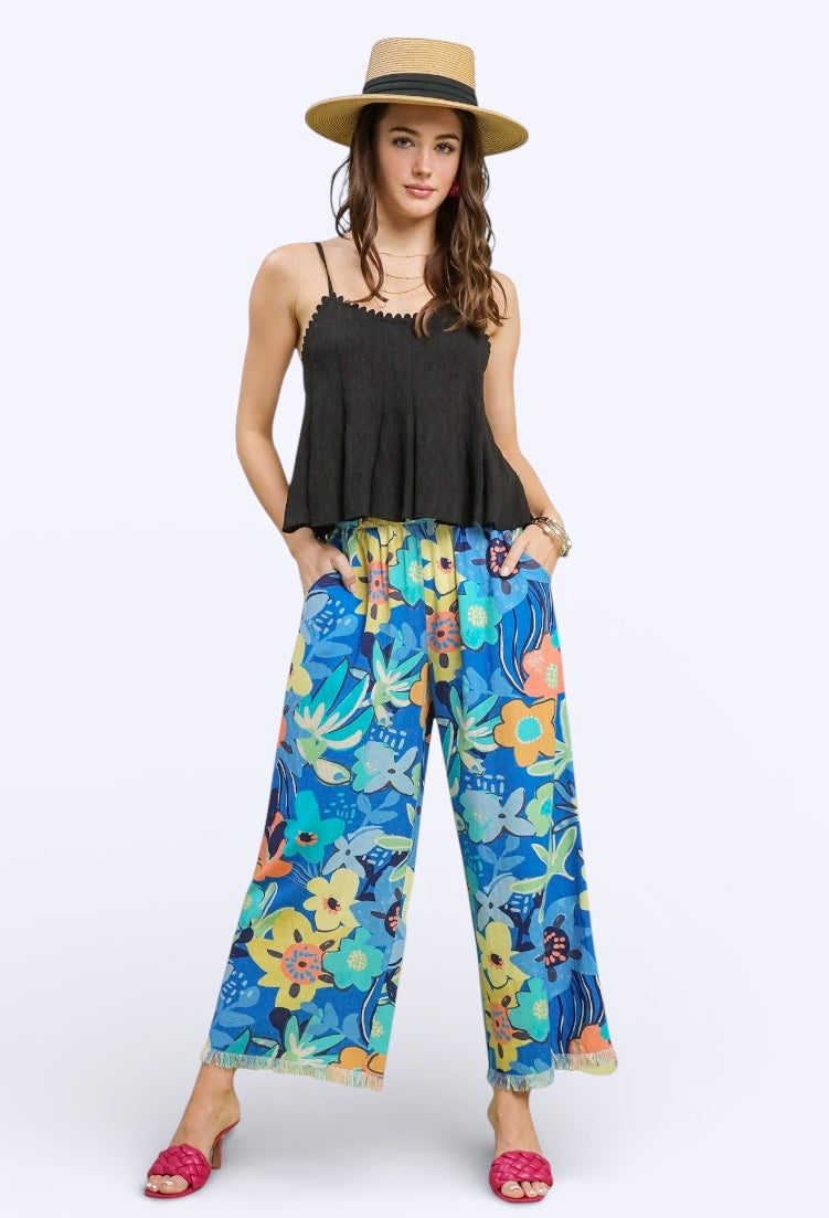 Umgee floral print wide-leg pants in blue with colorful flowers, frayed hem