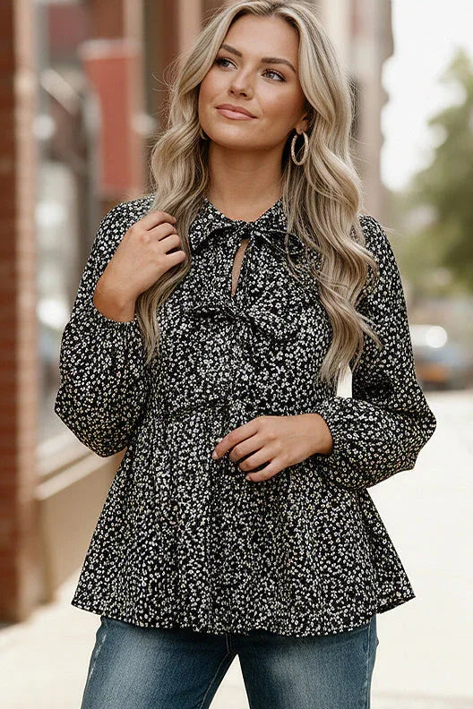 Leopard print peplum top with ruffled collar and long sleeves