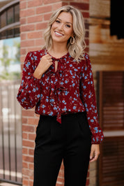 Cranberry Bloom Blouse with blue floral print and ruffled tie neckline