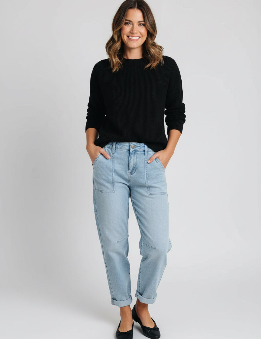 Light blue high-rise barrel relaxed boyfriend jeans with rolled cuffs and black shoes