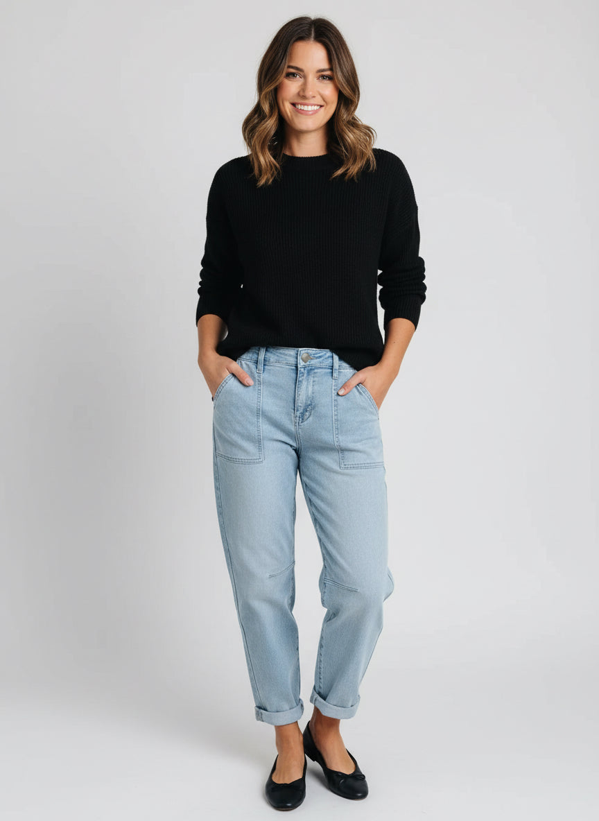 Light blue high-rise barrel relaxed boyfriend jeans with rolled cuffs and black shoes