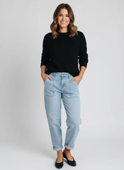 Light blue high-rise barrel relaxed boyfriend jeans with rolled cuffs and black shoes