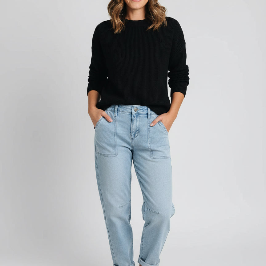 Light blue high-rise barrel relaxed boyfriend jeans with rolled cuffs and black shoes
