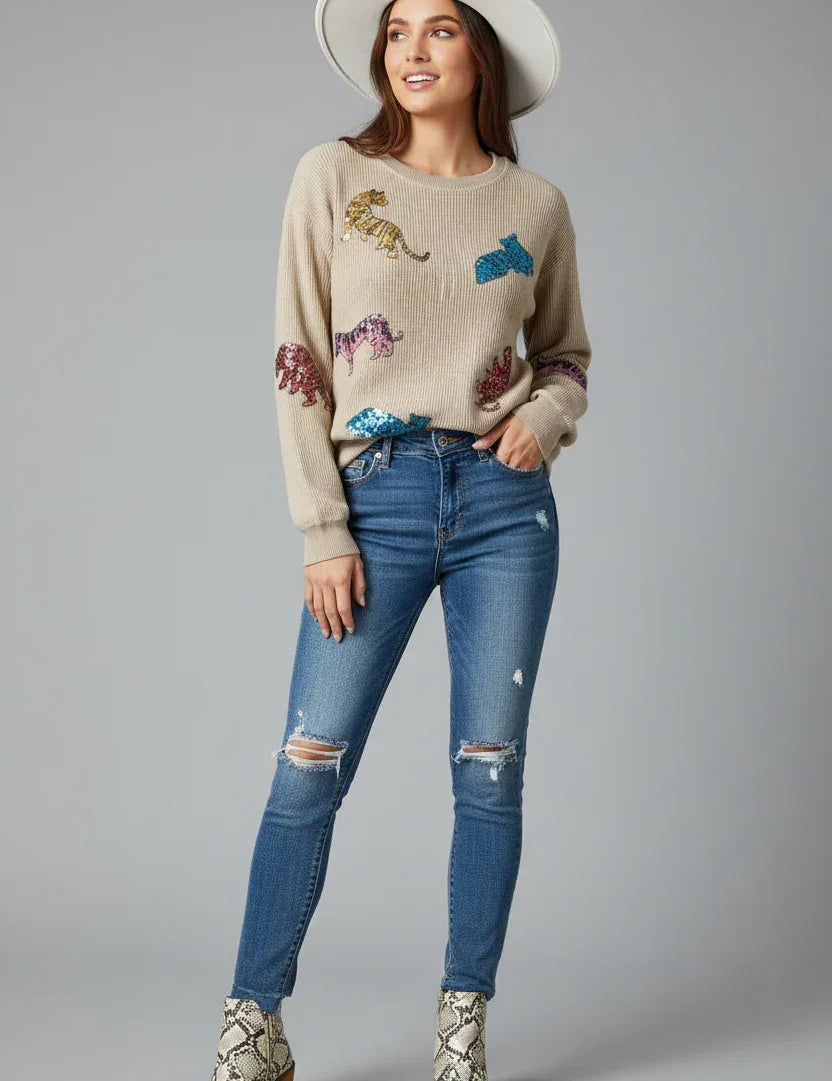 Beige dinosaur sequin dropped shoulder sweatshirt with embroidered details and distressed jeans