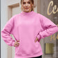 Soft pink oversized mock neck dropped shoulder sweatshirt with relaxed fit and ribbed cuffs