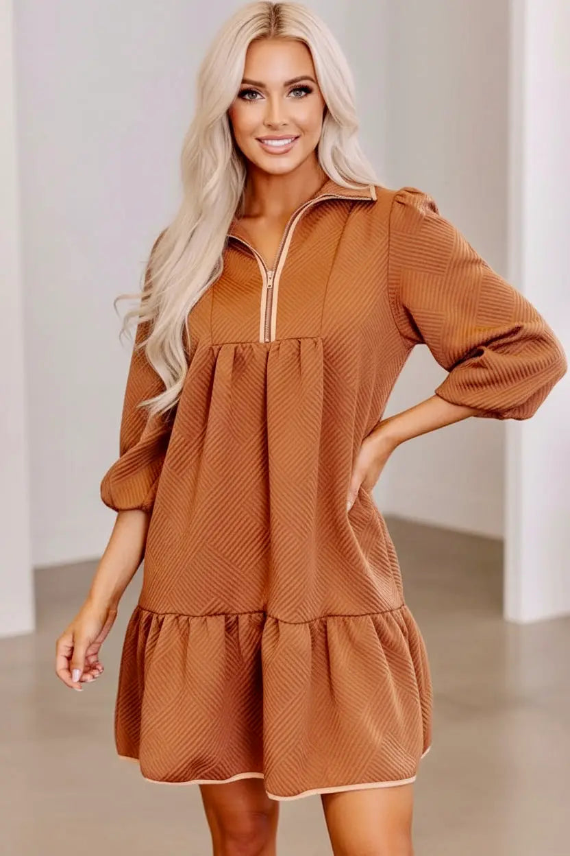 Ruffled hem zip front texture dress with brown textured fabric, zipper neckline, three-quarter sleeves, and tiered skirt